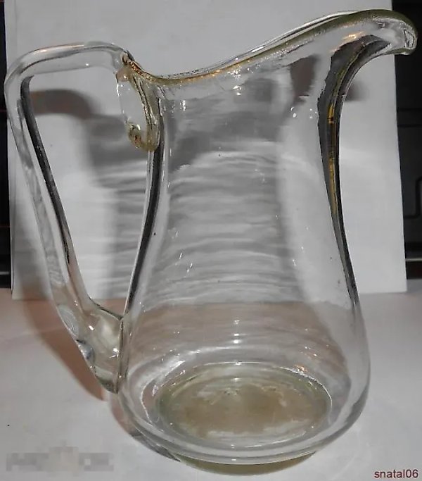 An antique, beautiful milk jug
