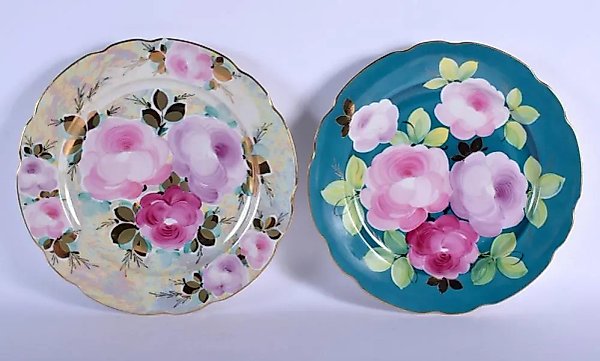A PAIR OF SOVIET RUSSIAN PORCELAIN PLATES FROM DULEVO, featuring bright flowers. Width 34 cm.