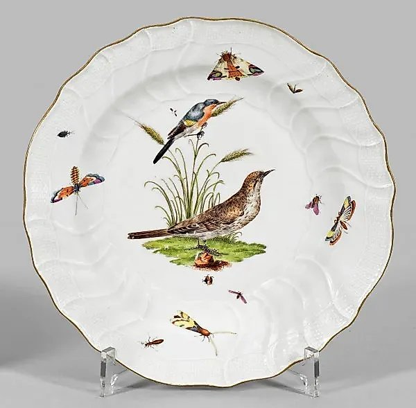 Decorative plate with a design of a bird and an insect