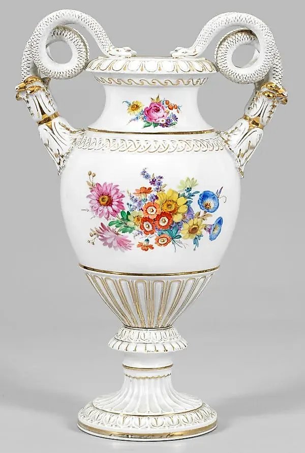 Vase with a handle in the shape of a snake and floral decor