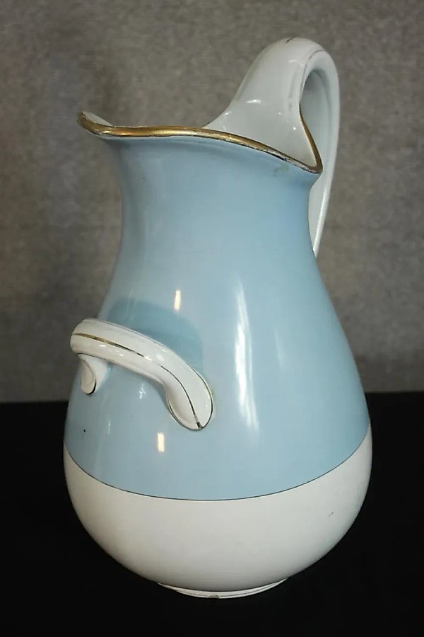Kuznetsov porcelain jug with a gold rim and light blue coloring.