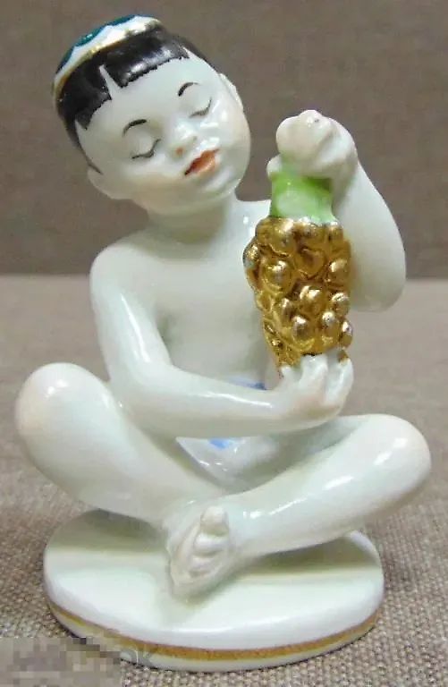 Porcelain figurine USSR. Boy with grapes.