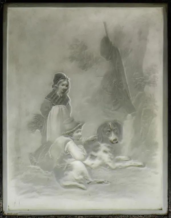 A lead frame with a porcelain lithograph depicting two children with a dog