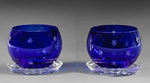 A pair of candlesticks from St. Louis with a star-shaped decoration.