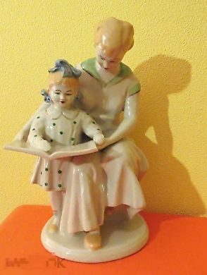 A mother and a girl are reading a book