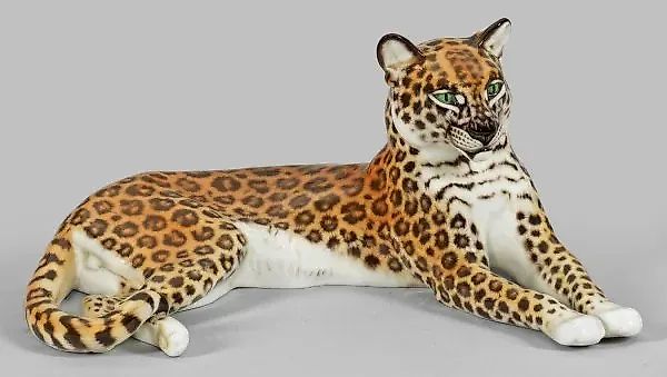 Porcelain figure of a reclining leopard