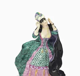 A PORCELAIN FIGURE OF A LADY WITH A MASK