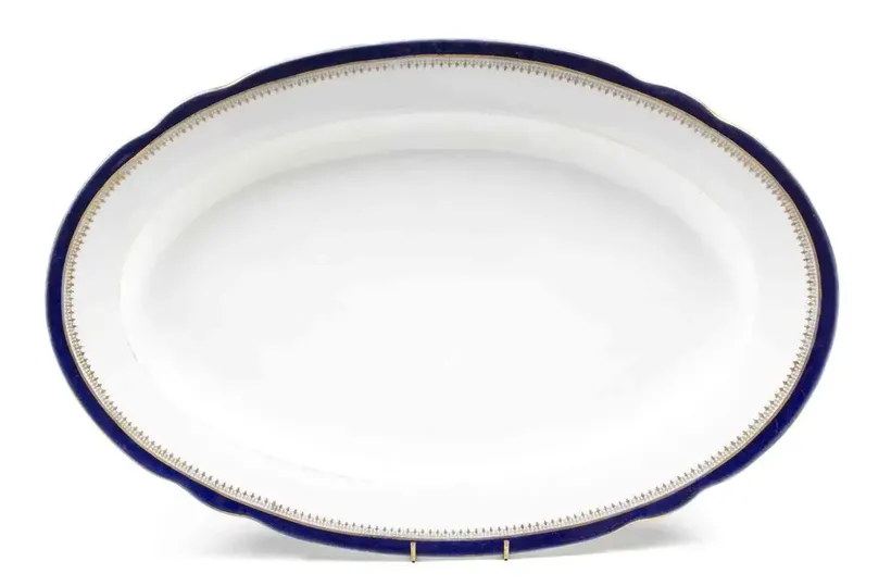 A Russian Porcelain Platter, Kuznetsov,of oval form with a gilt and navy border, signed.Width 21