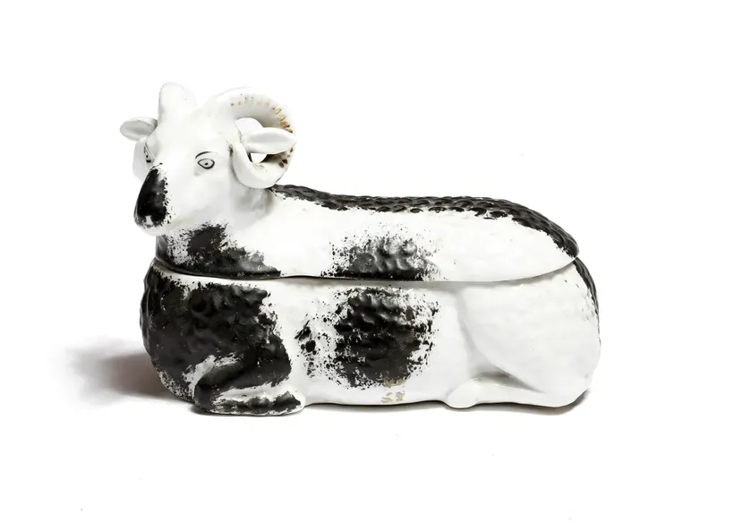 A late 19th century Russian Kuznetsov porcelain box and cover, in the form of a recumbent ram,