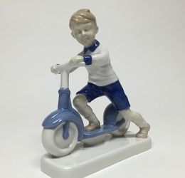 The boy on a scooter.