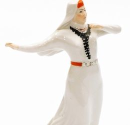 A Russian porcelain figure, possibly dating to the 1940s from the Dulevo factory, depicting lady da