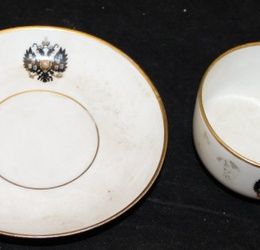A Kuznetsov porcelain cup and saucer bearing the Arms of Tsar Nicholas II,