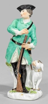 A hunter with a rifle and a dog