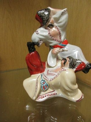 A Kiev Experimental porcelain group of two cossacks dancing, 23cm high