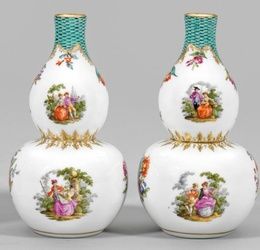 A pair of decorative vases with Watteau and floral decor.