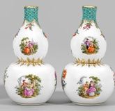 A pair of decorative vases with Watteau and floral decor.