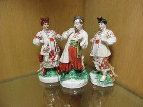 Two Kiev porcelain figures of Odarka and another of Ivan Karas based on the comic opera, she