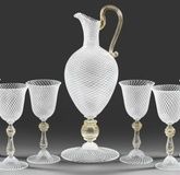 Decanter and six wine goblets with reticello decoration.
