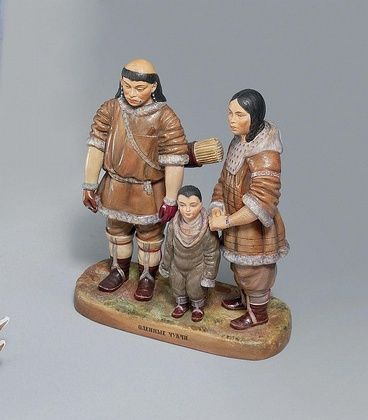 A LARGE PORCELAIN GROUP OF A CHUKCHI FAMILY
