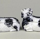 Pair Late 19th Century Russian Kuznetsov Porcelain Ram-Form Boxes. Signed with Blue Kuznetsov Backstamp on Bottom. One With Losses on Underside of Interior Rim, The Other with Hairline on Interior Bottom. Measures 4-1/2 Inches Tall, 6-1/2 Inches