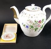 A Russian teapot by Kuznetsov, the porcelain body painted with floral sprigs and gilding, 20cm high,
