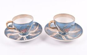 A pair of Imperial Russian Kuznetsov porcelain cups and saucers circa 1891-1917, the cups with