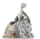A porcelain figure of a Lady with a rose