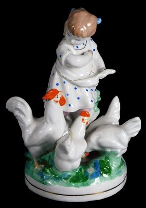 A Russian Dulevo porcelain group of a young girl, feeding chickens, in green, white and orange, 17cm