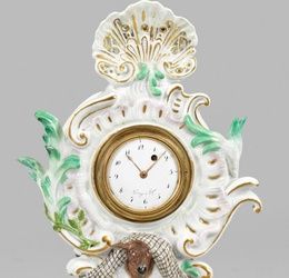 Small Rococo mantel clock with deer head and Boucher putti decor.