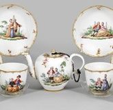 Tea pots and decorative cups with cotton decor.