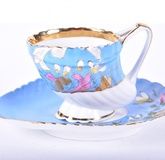 An Imperial Russian Kuznetsov porcelain cup and saucer circa. 1891-1917, the shell shaped cup with