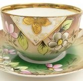 19/20th Century Russian Kuznetsov Porcelain Factory Painted and Gilt Porcelain Tea Cup and Saucer with Inscription "Day of the Angel". Signed and with Imperial Warrant Mark. Rubbing to Gilt and Very Small Chip to Rim of Saucer Otherwise Good