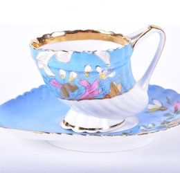 An Imperial Russian Kuznetsov porcelain cup and saucer circa. 1891-1917, the shell shaped cup with