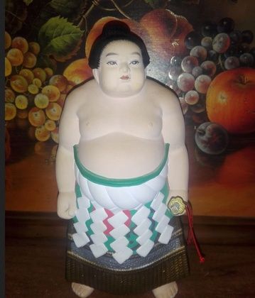 Japanese figurine Sumo wrestler Sumo in ceremonial attire with a katana by Hakata workshop.